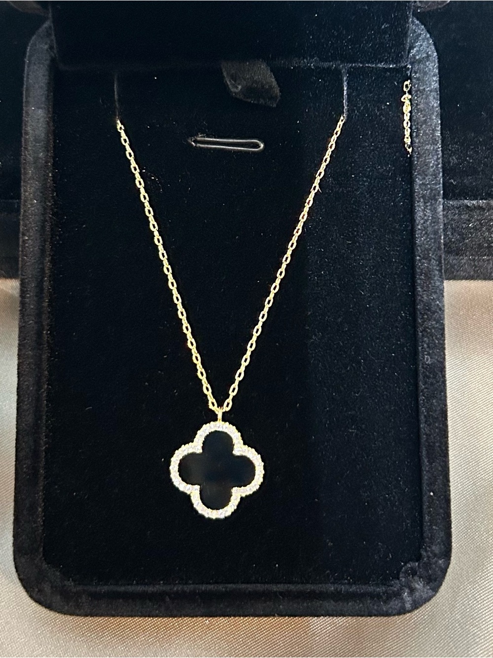 Gold Tone Clover Pendant Necklace with Black Enamel framed in CZ
